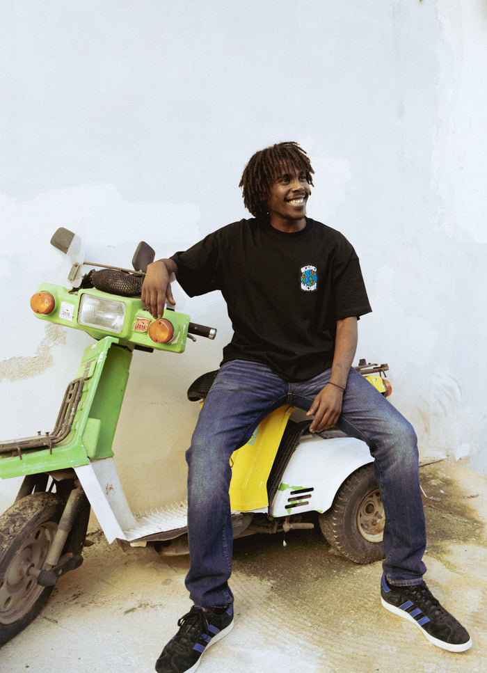 Black Patch WorldWide Tee — back